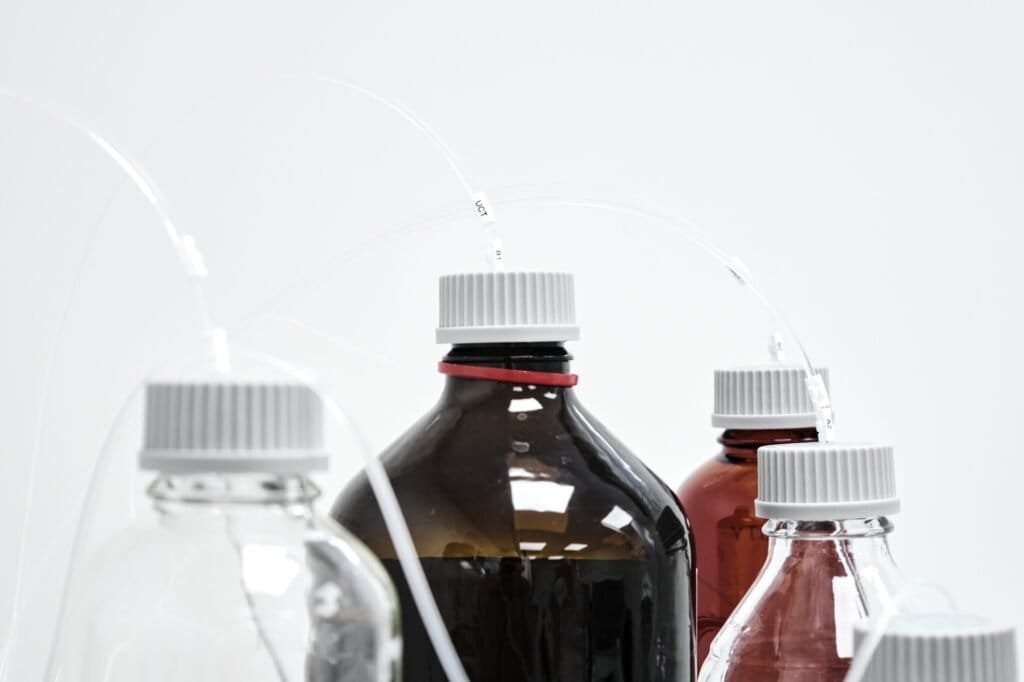Bottles with mobile phase for high performance liquid chromatography. HPLC system for separation of