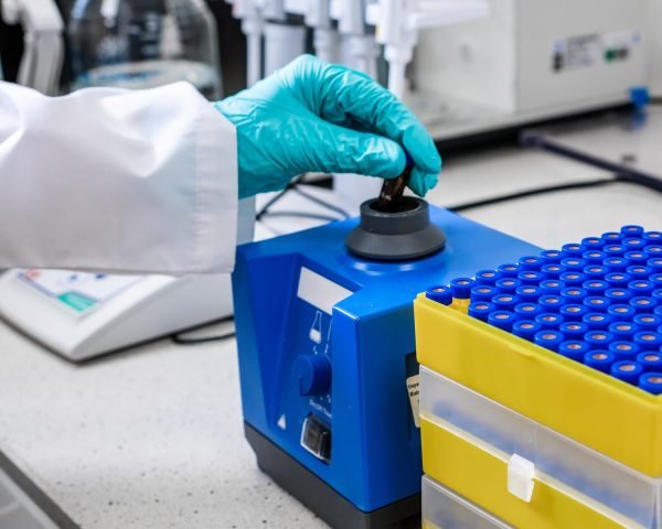 Before HPLC analysis, a chemist agitates the samples using a vortex mixer.